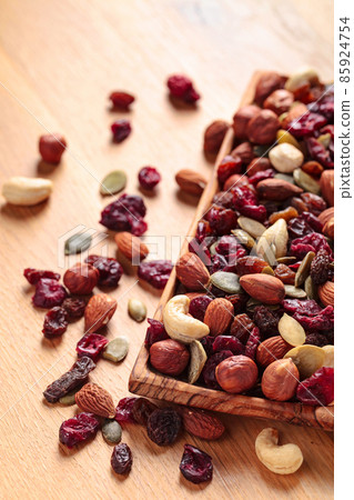 Close-up of mixed nuts, dry fruits, and berries. 85924754