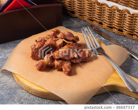 chicken stomachs cooked smoked on a wooden Board. Beer snack 86687337