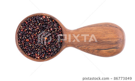 Black quinoa seeds in wooden spoon, isolated on white background. Pile of raw kinwa. Top view. 86773849