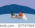 Man and woman sitting on chairs with a dog at picnic in the mountains 87747968