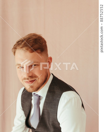 fashion young man wearing black tuxedo, grain effect studio blond 88752552