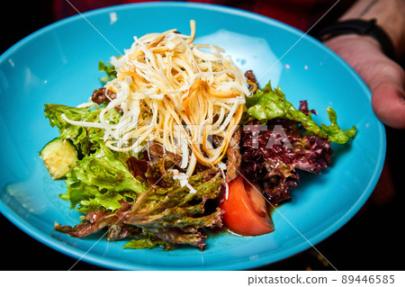 Warm salad with beef and smoked cheese. Close-up, selective focus. 89446585