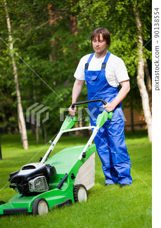 lawn mower man on the backyard 90138554