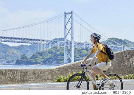 A local woman enjoying cycling on the Shimanami Kaido 90243500