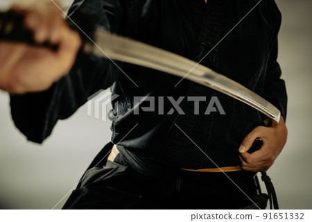 A person holding a Japanese sword 91651332