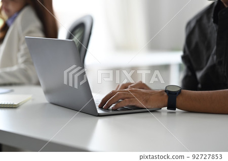 Cropped view of male employee typing business email, checking information on laptop computer 92727853