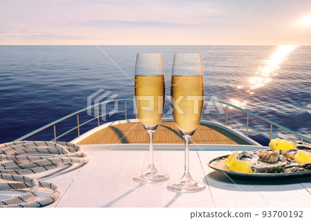 Exotic country voyage. Champagne flutes glasses on deck of luxury cruise ship during honeymoon holidays. Love, travel, vivid impressions 93700192