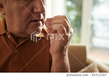 Cropped image of elderly man taking prescribed tablets to get rid of pain 93311587