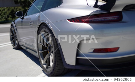 Rear view of the silver Porsche 911 GT3RS standing in the parking lot 94562905