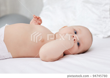 newborn baby girl in the white bed 94745780