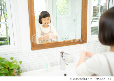 Elementary school girl washing hands in the washroom 95683955