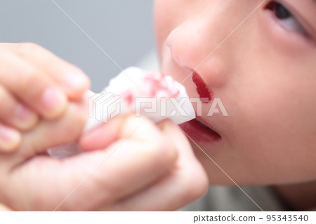 Elementary school girl with nosebleed (image with blood) 95343540