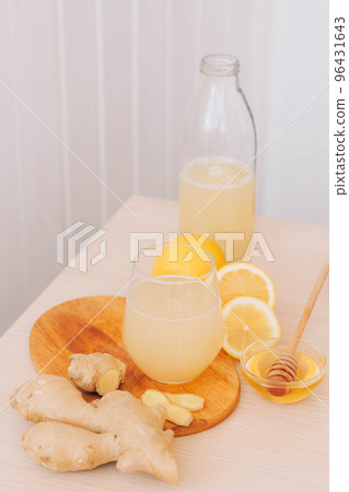 Trendy drink made from fresh lemon ginger root honey in glass. Antioxidant health drink, vitamins 96431643