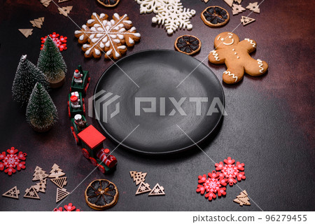 Home festive Christmas table decorated by toys and gingerbreads 96279455