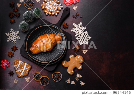 Beautiful different Christmas decorations and croissant on a brown concrete table 96344146