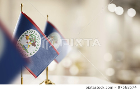 Small flags of the Belize on an abstract blurry background 97568574