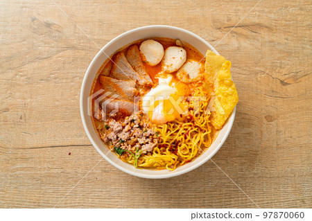 egg noodles with pork and meatball in spicy soup 97870060