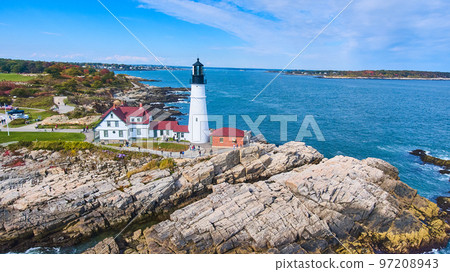 Rocky coastline aerial view of stunning Portland Head Light lighthouse in Maine 97208943