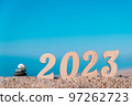 creative Christmas card. new year numbers 2023 on the beach by the sea with a cairn. copy space. selective focus. 97262723