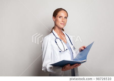 Portrait of optimistic mid adult female doctor indoor 98726510