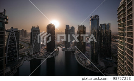 Sunrise over tall residential buildings at JLT aerial all day 98757238