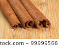 Cinnamon sticks on a wooden background. Fragrant cinnamon seasoning close-up. Spices with cinnamon. Food cooking video concept. ingredients for warm wine, mulled wine 99999566