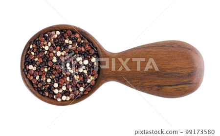 Quinoa seeds in wooden spoon, isolated on white background. Mix of white, red and black quinoa. Top view. 99173580