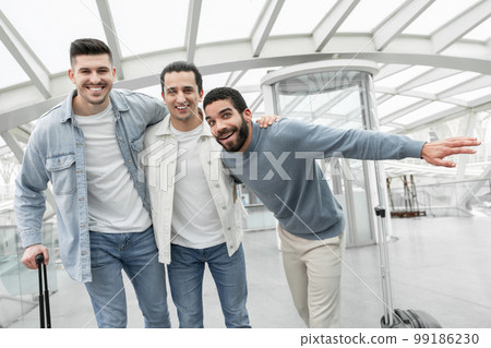 Three Tourists Guys Posing With Suitcases Having Fun In Airport 99186230