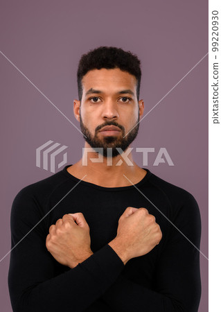 Portrait of young multiracial man in studio. 99220930