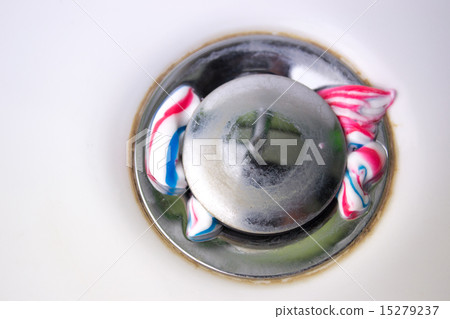 round drain hole in white sink with toothpaste 15279237