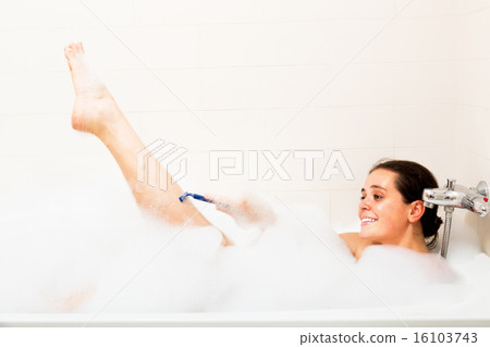 Woman shaving legs in bath 16103743