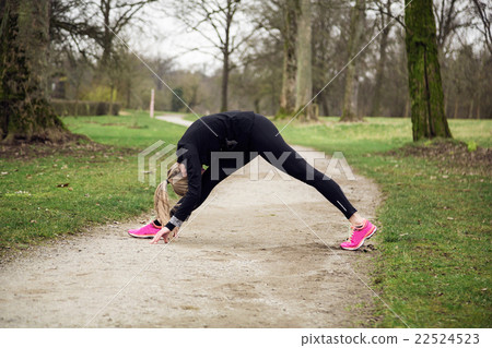 attarcive woman stretching in park 22524523