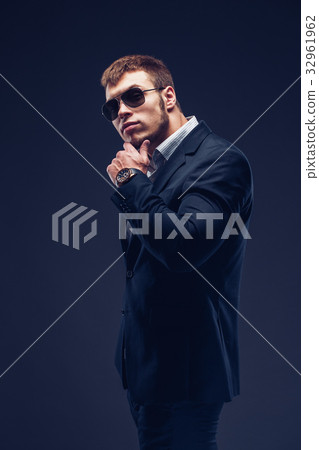 Fashion young businessman black suit on dark 32961962