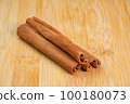 Cinnamon sticks on a wooden background. Fragrant cinnamon seasoning close-up. Spices with cinnamon. Food cooking video concept. ingredients for warm wine, mulled wine 100180073