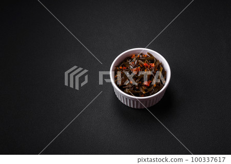 Delicious marinated seaweed with paprika, spices and salt 100337617