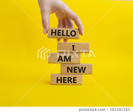 Hello I am a new hire symbol. Concept words Hello I am a new hire on wooden blocks. Beautiful yellow background. Businessman hand. Business and Hello I am a new hire concept. Copy space. 101391583