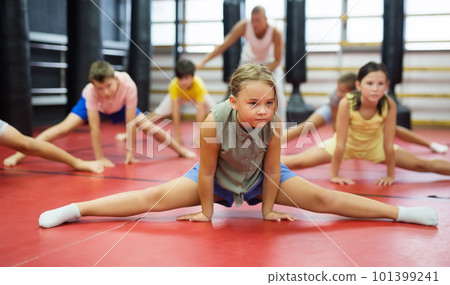 Girl doing splits during training at sport class 101399241