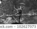 IRPIN, UKRAINE - NOVEMBER 29, 2022: Gymnast with ribbon - Banksy graffiti in Irpin, Ukraine, black and white photo 102627073