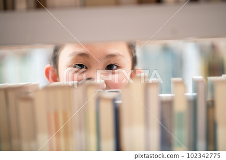 child looking for a book 102342775