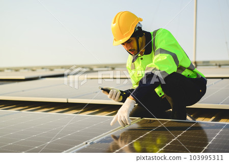 Engineer worker working at solar cell power plant with sunset 103995311