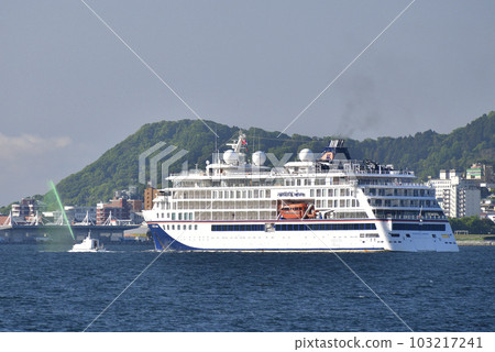 Photographing the scenery of the cruise ship Hanseatic Nature that calls at Hakodate Port in Hakodate City, Hokkaido in early summer 103217241