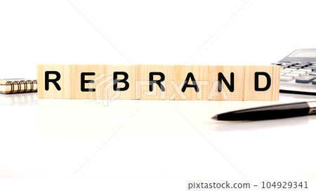 REBRAND word written on wood block on a white background 104929341