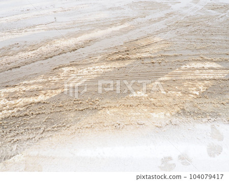 Snow, ice, slush and winter mud at a pedestrian crossing. The air temperature is about 0. Difficult driving conditions. Braking distance of the car. Traffic Laws. Infrastructure and road services. 104079417