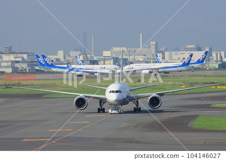 Passenger plane towed on tarmac Haneda Airport operation 104146027