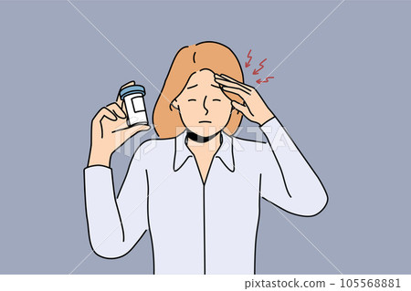 Woman suffers from headache and demonstrates package of medicines to cope with migraine 105568881