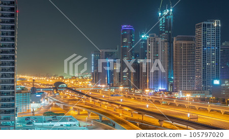 Dubai Marina skyscrapers and Sheikh Zayed road with metro railway aerial all night timelapse, United Arab Emirates 105797020