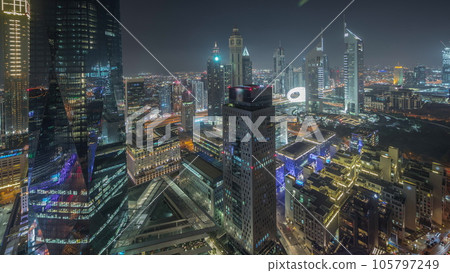 Panorama showing futuristic skyscrapers in financial district business center in Dubai night timelapse 105797249