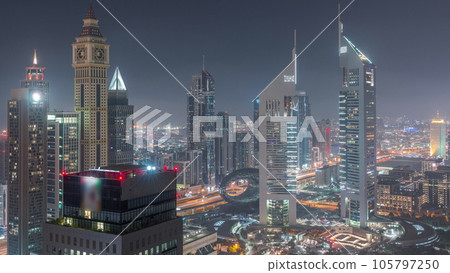 Skyscrapers on Sheikh Zayed Road and DIFC day to night in Dubai, UAE. 105797250