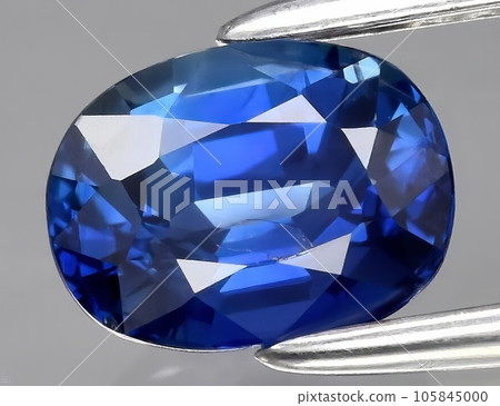 Natural gemstone blue sapphire on gray background 105845000