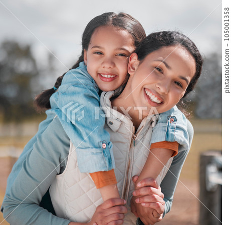 She loves the outdoors as much as I do. a little girl and mother spending time together on a ranch. 105001358